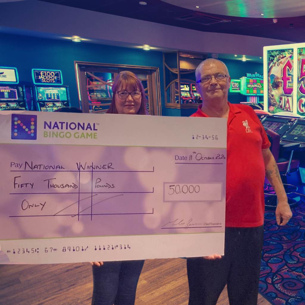 National Bingo Game winners holding a cheque for £50,000