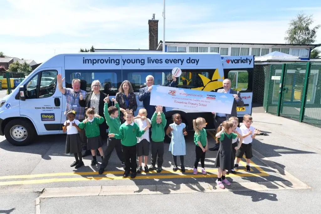 Children celebrating the arrival of their new Sunshine Coach.